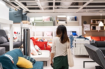 young woman choosing furniture modern home furnishings store